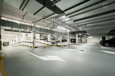 an empty parking garage with cars parked in it at SettlerHomes - Chic Creek Edge 1BR With Harbour View in Dubai