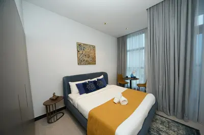 a hotel room with a bed and a window at Cosy Studio on the Binghatti Canal in Dubai