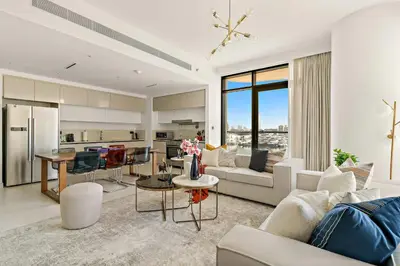 a living room with white furniture and a kitchen at Silkhaus Large 3BR plus Maid Room Elegant Marina View in Dubai
