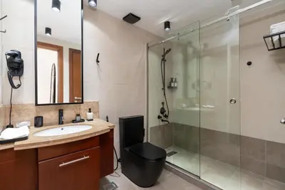 a bathroom with a shower and a toilet and a sink at Downtown,Fountain view, nearBurj Khalifa,3 minutes walk to Dubai Mall in Dubai