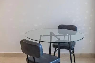 two chairs and a glass table and a table and two chairs at Heart of DIFC 1 BR LUX - Exceptional View in Dubai