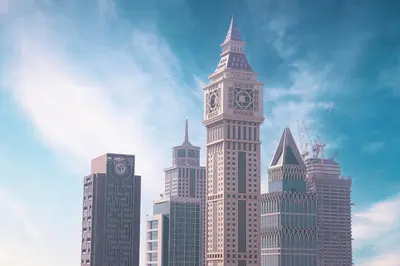 a tall building with a clock tower in a city at Heart of DIFC 1 BR LUX - Exceptional View in Dubai