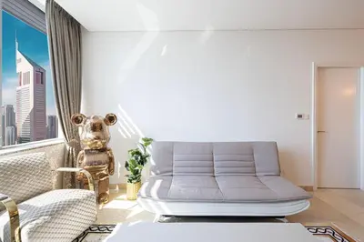 a living room with a couch and a window at Heart of DIFC 1 BR LUX - Exceptional View in Dubai