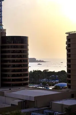 a view of a building with the ocean in the background at Vacation Friendly Beach View Luxury 1Bedroom- Walk To Beach & Mall in Dubai