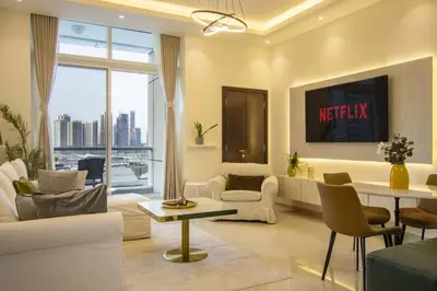 a living room with white furniture and a large window at Vacation Friendly Beach View Luxury 1Bedroom- Walk To Beach & Mall in Dubai