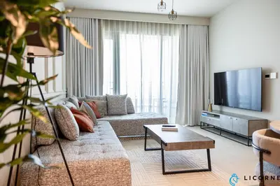 a living room with a couch and a flat screen tv at New Stylish 1BR Apartment, Next to Dubai Mall - Downtown Views ll, Tower 3 in Dubai