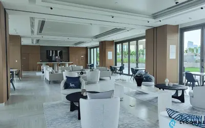 a lobby with white chairs and tables and windows at Top Floor Urban Oasis Steps from Dubai Mall - 1BR Apartment in Downtown Views ll, Tower 1 in Dubai