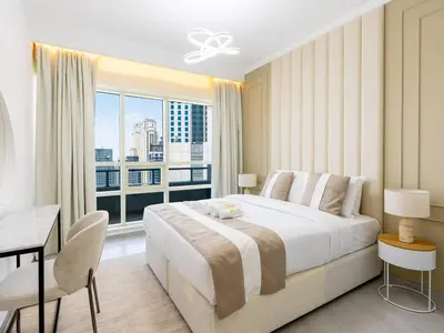 a bedroom with a large bed and a large window at 2 Bedroom Smart Home with a Panoramic Marina View in Dubai