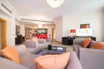 a large living room with couches and a living room at Spacious 3 Bedroom Palm Apartment in Dubai
