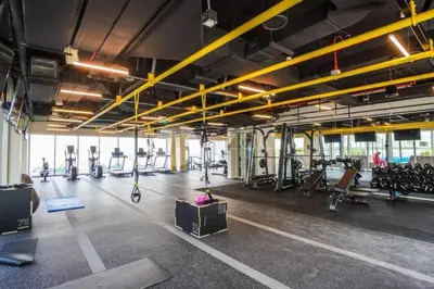 a gym with several treadmills and exercise bikes at Socio Tower 2 - Neat One Bedroom in Dubai