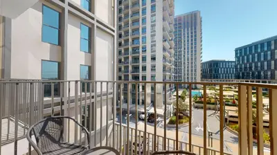 a balcony with a view of a city with tall buildings at Socio Tower 2 - Neat One Bedroom in Dubai