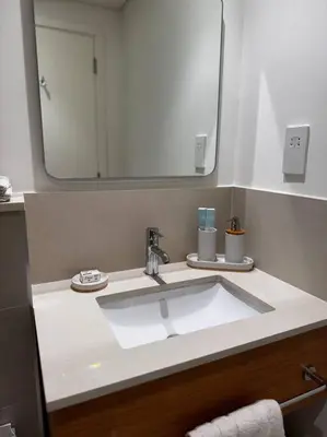 a bathroom with a sink and a large mirror at Golfville LighthouseDubai Hills in Dubai