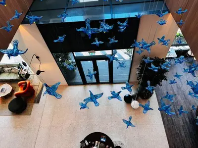 an overhead view of a living room with blue butterflies at Golfville LighthouseDubai Hills in Dubai