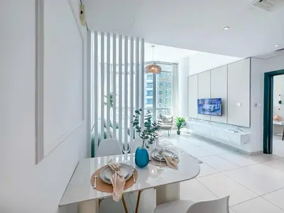 a white kitchen with a dining table and chairs at Amazing Roof Top Pool in Nice 1 BHK Flat in Marina in Dubai