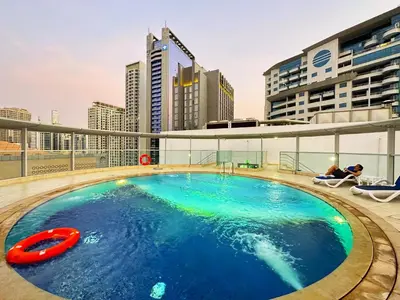 a swimming pool on the roof of a building at Amazing Roof Top Pool in Nice 1 BHK Flat in Marina in Dubai