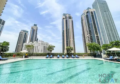 a swimming pool in a city with tall buildings at Luxurious 2 BR- Dubai Creek Harbour - Host & Stay in Dubai