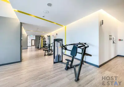 a fitness room with treadmills and a gym at Luxurious 2 BR- Dubai Creek Harbour - Host & Stay in Dubai