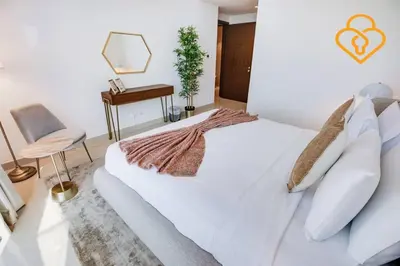 a bedroom with a white bed and a desk at Keysplease 3 BR Burj View, Dubai Mall Access Boulevard Point Tower in Dubai