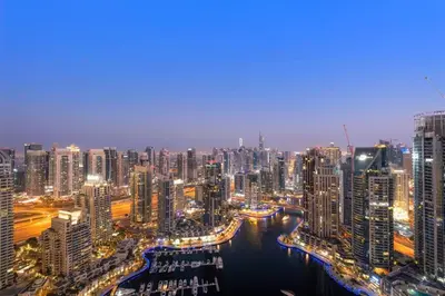 a view of a large city at night at Marina View 1BR Chic Stay in Dubai Vibrant Walk Near Dining & Attractions in Dubai