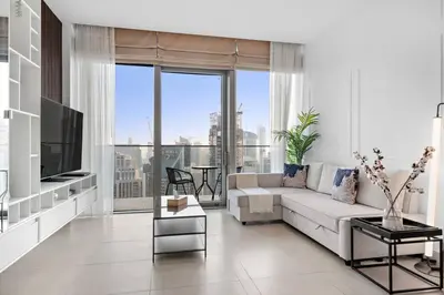 a living room with a couch and a tv at Marina View 1BR Chic Stay in Dubai Vibrant Walk Near Dining & Attractions in Dubai