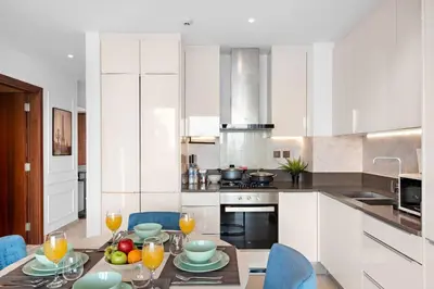 a kitchen with a table with glasses of orange juice at Marina View 1BR Chic Stay in Dubai Vibrant Walk Near Dining & Attractions in Dubai