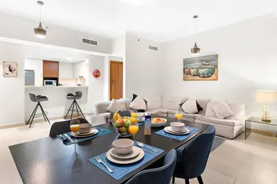 a living room with a table and a couch at Downtown 2BR Skyline Views & Prime Dubai Stay Near Burj Khalifa, Mall in Dubai