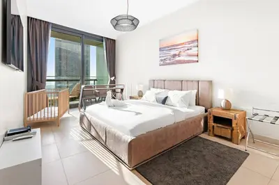 a bedroom with a bed and a large window at Downtown 2BR Skyline Views & Prime Dubai Stay Near Burj Khalifa, Mall in Dubai