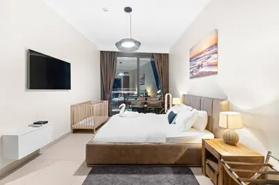 a bedroom with a bed and a living room at Downtown 2BR Skyline Views & Prime Dubai Stay Near Burj Khalifa, Mall in Dubai