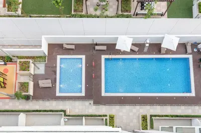 an overhead view of a swimming pool in a building at FIRST CLASS Studio Sophisticated Getaway in Dubai