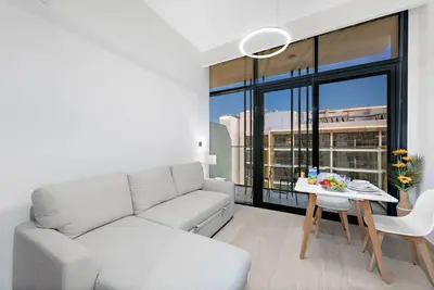 a living room with a couch and a table at FIRST CLASS Studio Sophisticated Getaway in Dubai
