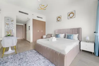a bedroom with a large white bed and a table at StoneTree - Fully Furnished - Brand New in Dubai