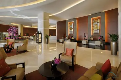 a lobby of a hotel with chairs and a table at Charming 1BR in The Address Residences Dubai Marina by Deluxe Holiday Homes in Dubai