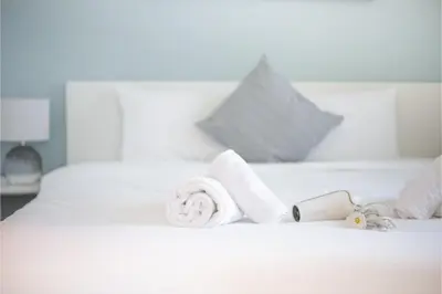 a white bed with towels on top of it at HAVN - 1 Bedroom in Dubai Marina with Sea Views in Dubai