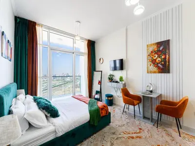 a bedroom with a bed and a large window at Studio in Damac Hills - Modern Comfort with Premium Amenities,by Think Realty in Dubai