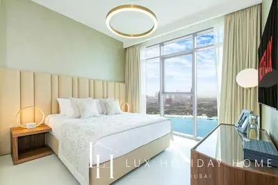 a bedroom with a bed and a large window at LUX The Marina Vista Beachfront Suite 3 in Dubai
