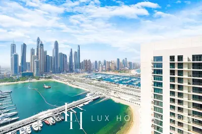 an aerial view of a city with a harbor at LUX The Marina Vista Beachfront Suite 3 in Dubai