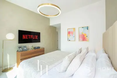 a bedroom with a white bed and aokedokedokedoked at LUX The Marina Vista Beachfront Suite 3 in Dubai