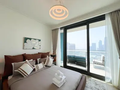a bedroom with a large bed with a large window at Stylish 2BR Burj Khalifa & Fountain View Downtown - 37AB06 in Dubai