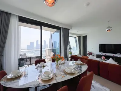 a dining room with a table and a couch at Stylish 2BR Burj Khalifa & Fountain View Downtown - 37AB06 in Dubai