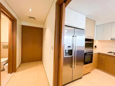 a kitchen with a stainless steel refrigerator at Stylish 2BR Burj Khalifa & Fountain View Downtown - 37AB06 in Dubai
