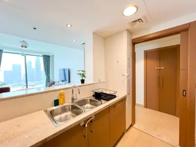 a kitchen with a sink and a large window at Stylish 2BR Burj Khalifa & Fountain View Downtown - 37AB06 in Dubai