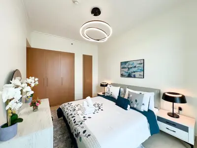 a bedroom with a large bed and a table at Stylish 2BR Burj Khalifa & Fountain View Downtown - 37AB06 in Dubai