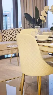 a dining room with a table and a white chair at Luxury 3 bedroom Aykon Tower in Dubai