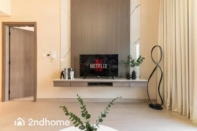a living room with a television on a table at 2ndHome - Laya Heights, Studio City in Dubai