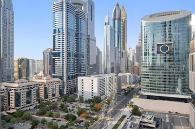 an aerial view of a city with tall buildings at Luxury DIFC 1BR Near Dubai Mall, Burj Khalifa with Skyline Views in Dubai