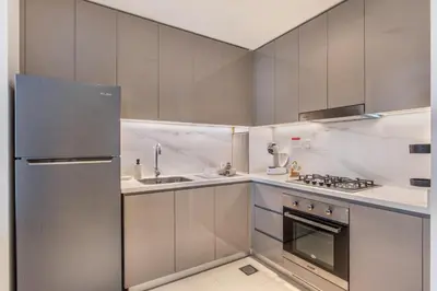 a small kitchen with a sink and a refrigerator at Fantastic1BR Furnished Apt at Azizi Park Avenue! in Dubai