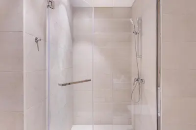 a bathroom with a shower with a glass door at Fantastic1BR Furnished Apt at Azizi Park Avenue! in Dubai