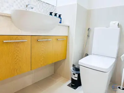 a bathroom with a sink and a toilet at 1BR Downtown Apt Walk to Dubai Mall & Burj in Dubai