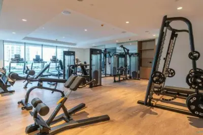 a gym with several tread machines in a room at Brand New 1BR Downtown - Next to Dubai Mall in Dubai