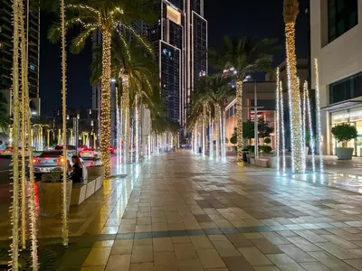 a street with palm trees and christmas lights at Brand New 1BR Downtown - Next to Dubai Mall in Dubai